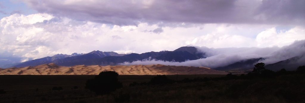 Colorado Sand Dunes with morning clouds rolling in over the Sangre de Cristo Mtn. Range